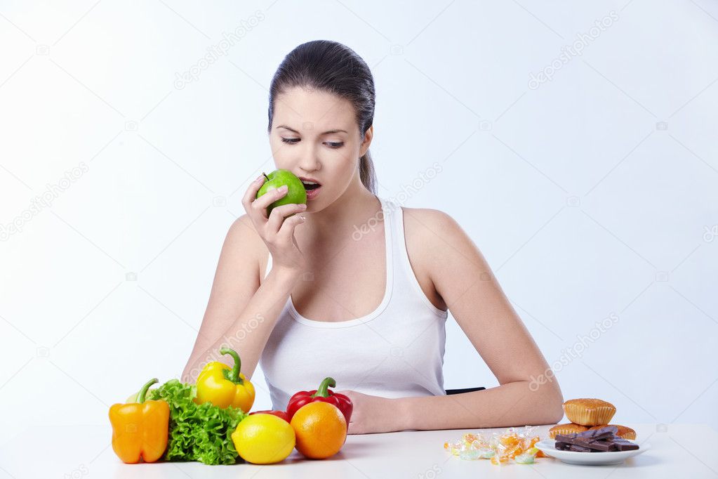 The girl is the apple and looks for dessert on a white background