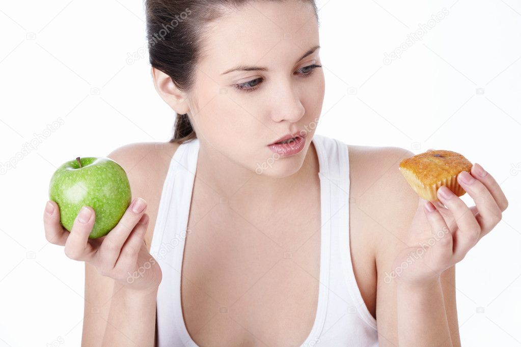 Attractive young girl with an apple and a cake isolated