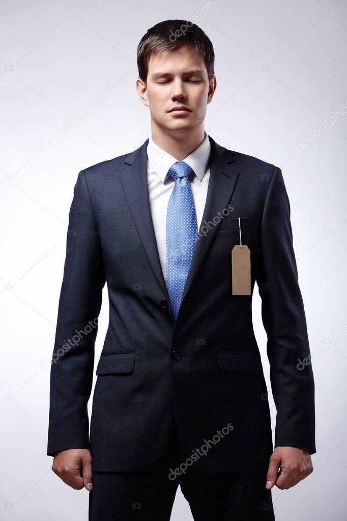Serious businessman wearing a suit with the tag