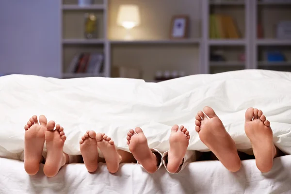 Feet under a blanket — Stock Photo, Image