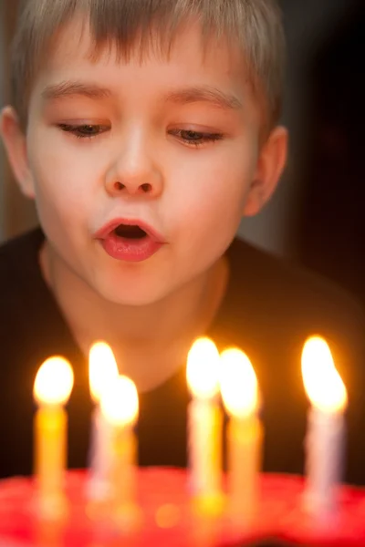 Stock image Boy blowing out candles on birthday cake