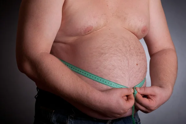 Kövér ember tartja a mérési szalag Stock Fotó