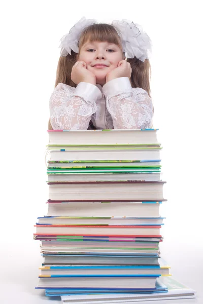 Schoolmeisje Leunend Een Stapel Boeken Witte Achtergrond — Stockfoto