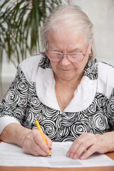 stock image Senor woman signing document