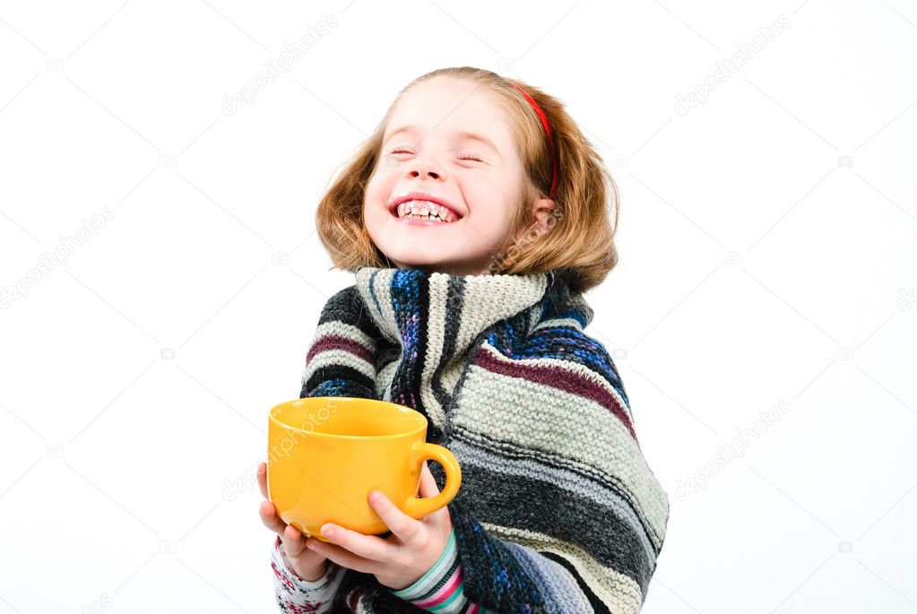 Studio shot of pretty little girl with a cold holding a cup