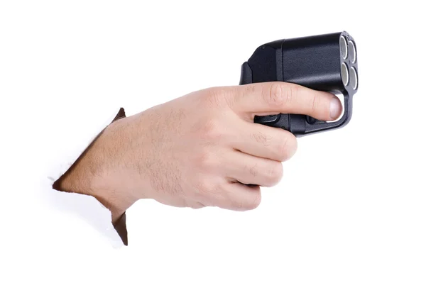 Hand med traumatiska pistol på vit — Stockfoto