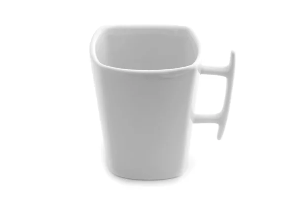 Біла чашка на білому фоні — стокове фото