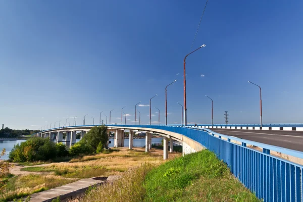 Blue bridge across the river — Stock Photo, Image