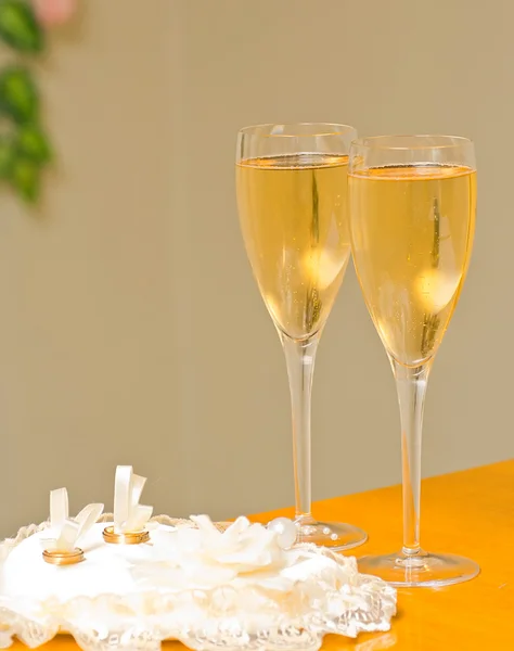 Wedding rings and champagne glasses — Stock Photo, Image