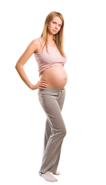 Bella giovane ragazza bionda incinta su sfondo bianco — Foto Stock