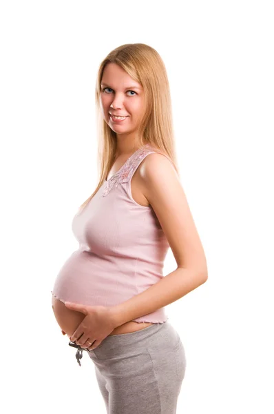 Szép, fiatal terhes szőke lány fehér háttér — Stock Fotó