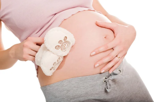 赤ちゃんのための白い靴のペアを保持している妊娠中の女性 — ストック写真