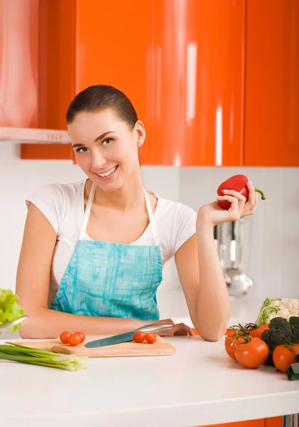 Mujer joven en su cocina ingredientes de corte — Foto de Stock