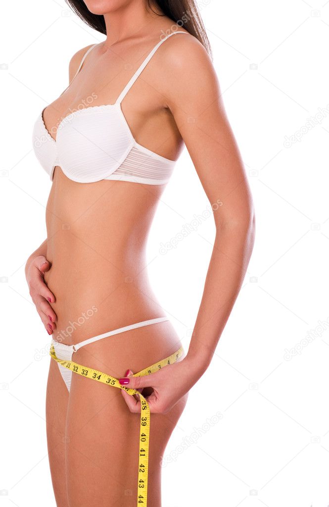 Young woman measuring her waist, isolated on white background