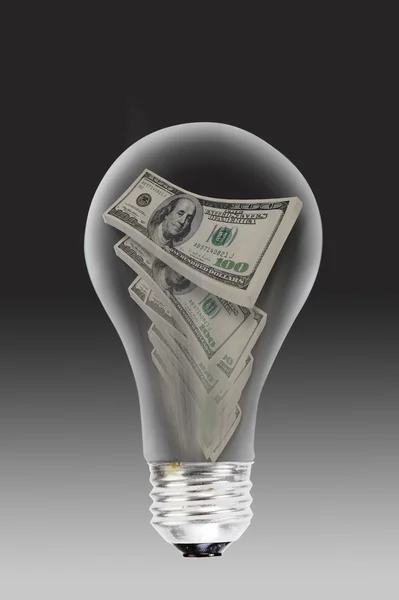 Light bulb and money. — Stock Photo, Image