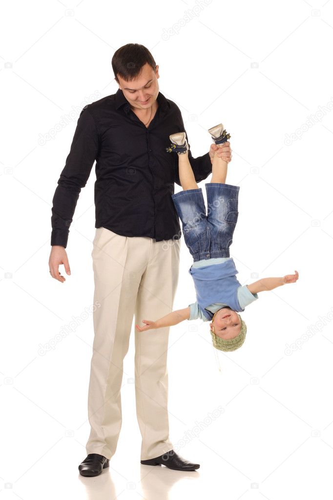 Man holds little boy upside down