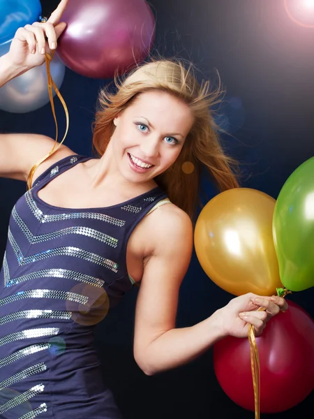 Smiling woman on party holding ballons — Stock Photo, Image