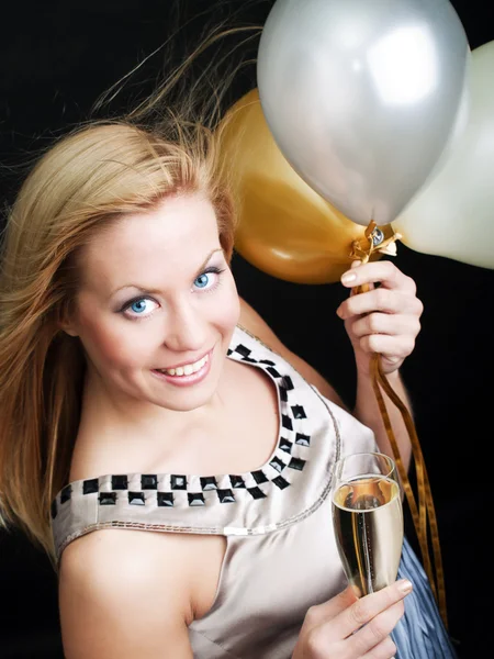 Sonriente mujer celebración de año nuevo champán y globos — Foto de Stock