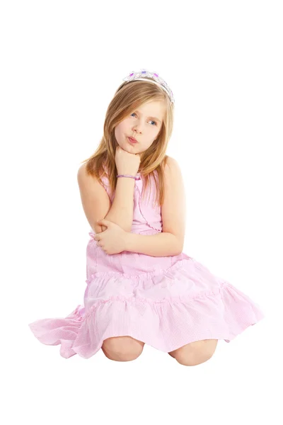 Pequena princesa irritada sentada sobre branco — Fotografia de Stock