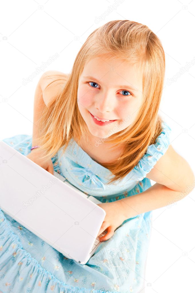 Smiling eight years old girl working with computer over white
