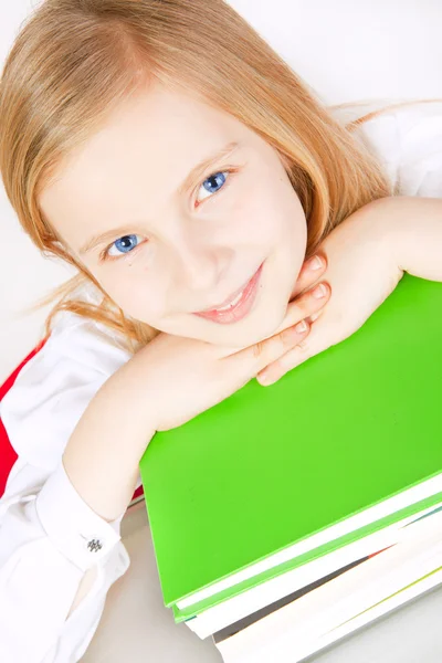 Menina pequena com livros na mesa — Fotografia de Stock