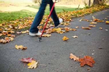 Nordic walking race on autumn trail - motion blur clipart