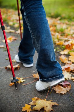 Nordic walking race on autumn trail clipart