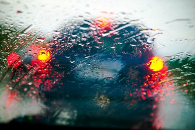 Car windshield in traffic jam during rain clipart