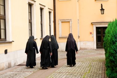 Nuns walking on the square clipart