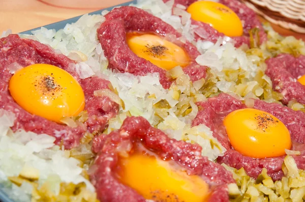 Tartar steak with egg onion and pickle — Stock Photo, Image