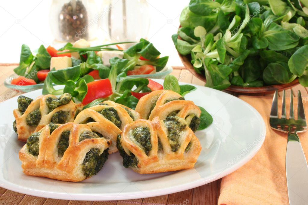Puff pastry with spinach and cheese filling on a white plate