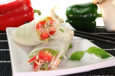 Lucky roll with lettuce, salmon, rice noodles, bell peppers and Thai basil clipart