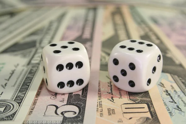 stock image Many dollar bills with fallen cubes with high scores