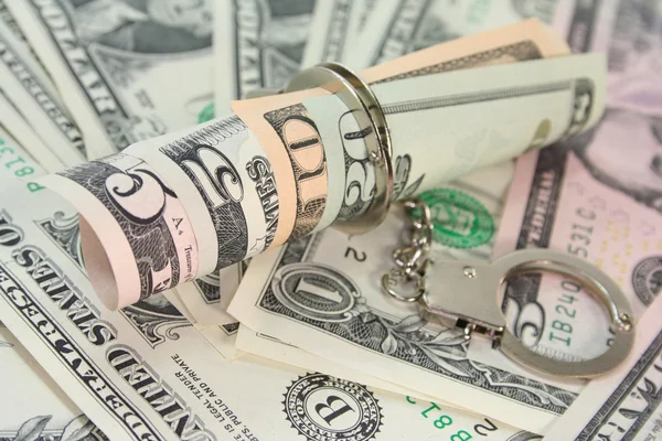 Dollar bills with handcuffs — Stock Photo, Image
