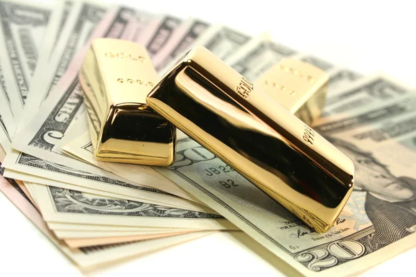 Gold bullion on dollar bills — Stok fotoğraf
