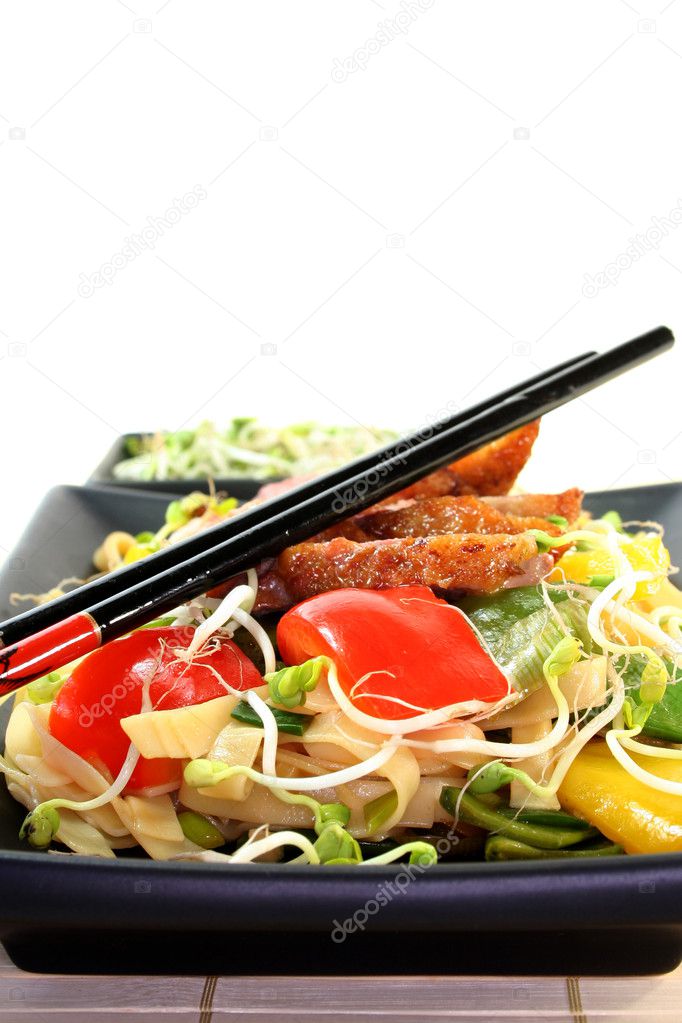 Crispy duck breast with fried noodles and vegetables