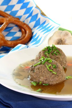 A plate of liver dumpling soup with chives clipart