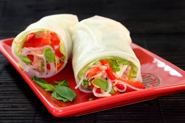 Rice paper filled with salmon, peppers and sprouts clipart
