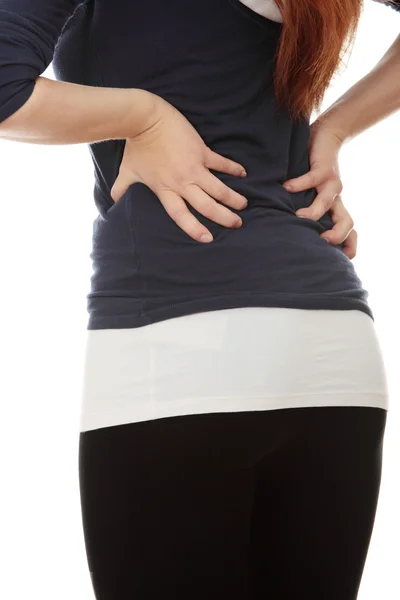Junge Frau mit Schmerzen im Rücken. — Stockfoto
