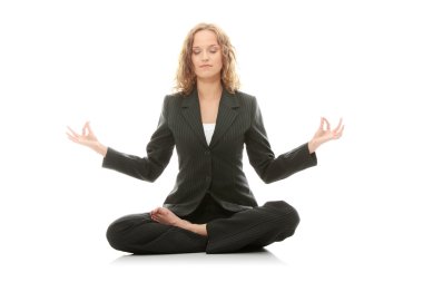 Beautiful businesswoman sitting on white desk in lotus flower position of yoga. Isolated on white clipart