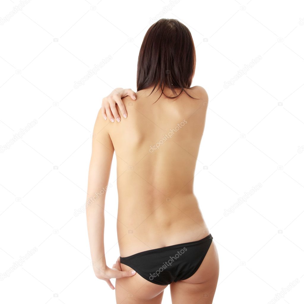 Nude woman from behind. Back pain concept. Isolated