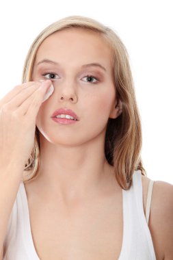 Teen woman removing makeup clipart