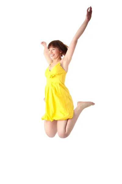 Молодая Улыбающаяся Девочка Жёлтом Летнем Платье Прыгает Изолированный Белом Фоне — стоковое фото