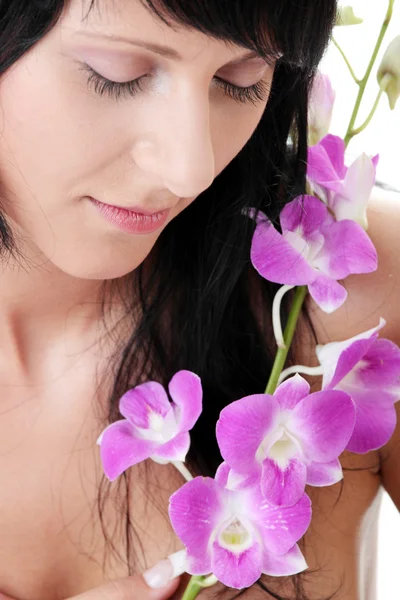Beautiful Caucasian woman and orchid — Stock Photo, Image
