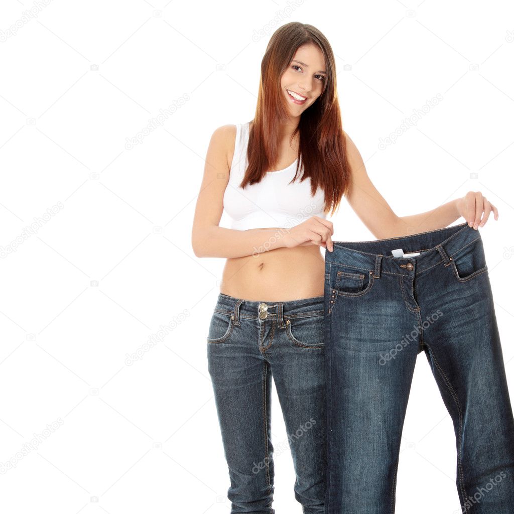 Woman showing how much weight she lost. Isolated
