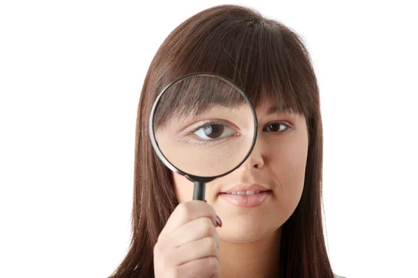 Businesswoman looking into a magniying glass — Stock Photo, Image