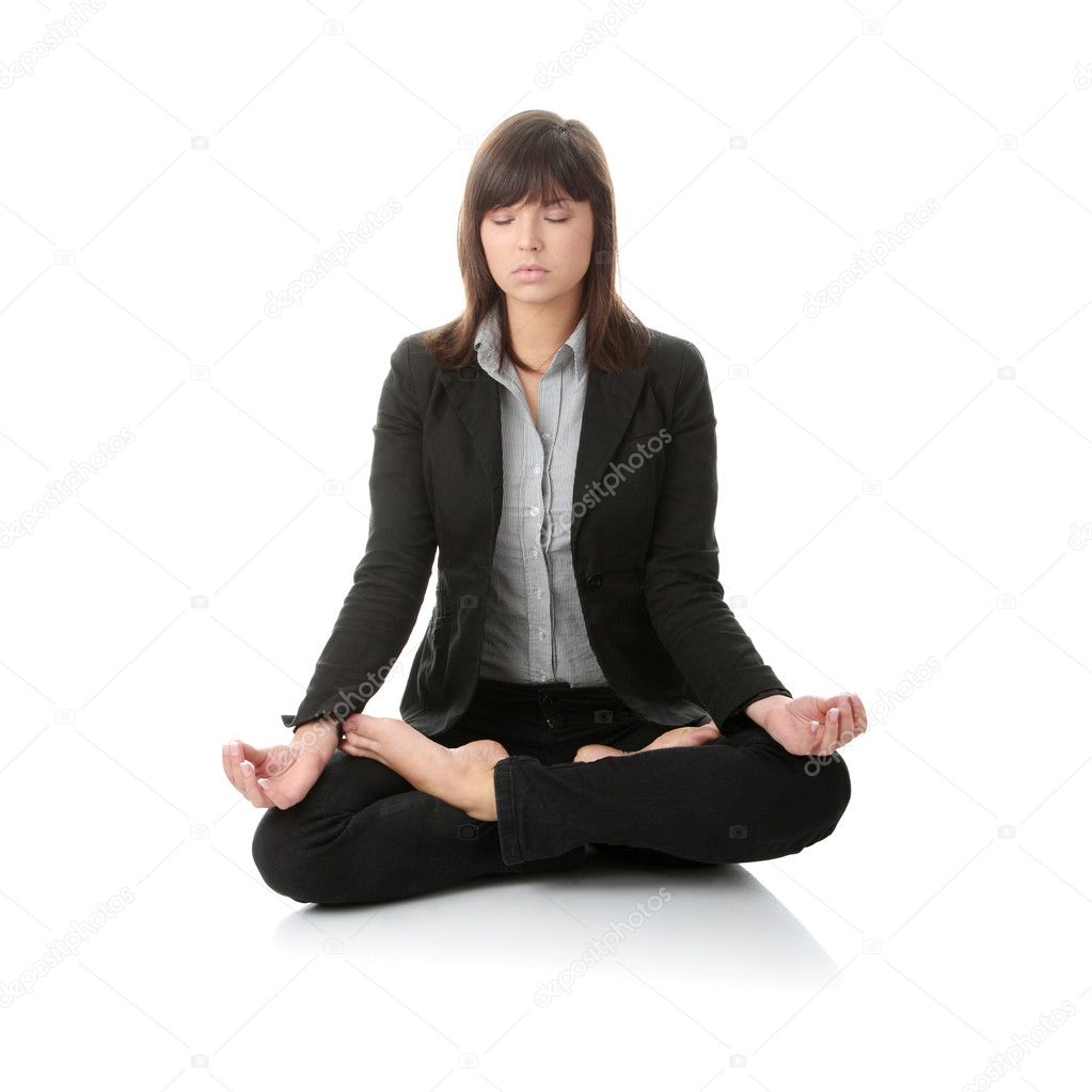 Businesswomen meditating in lotus position.