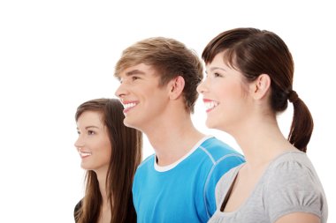 Three young happy friends. Two girls one boy smiling and looking left. Focus on male. Isolated on white background. clipart