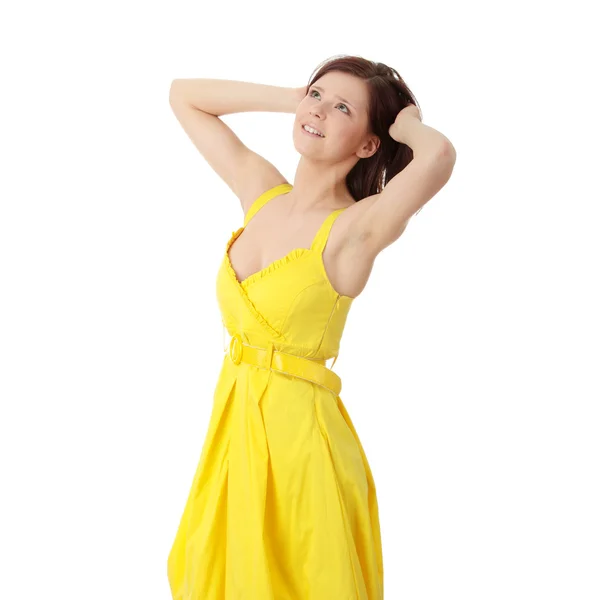 Beautiful brunette girl in yellow dress. — Stock Photo, Image