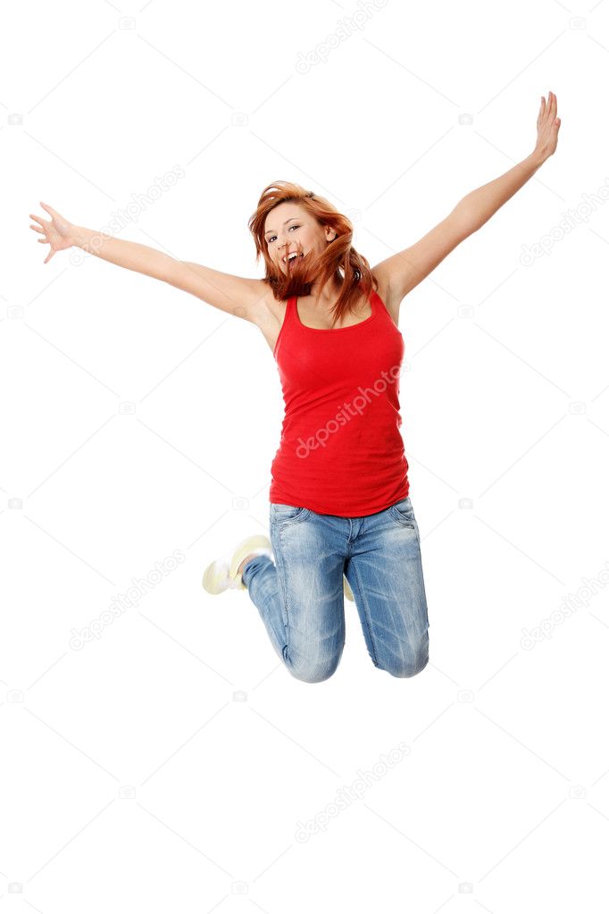 Young happy caucasian woman jumping in the air , isolated on white background